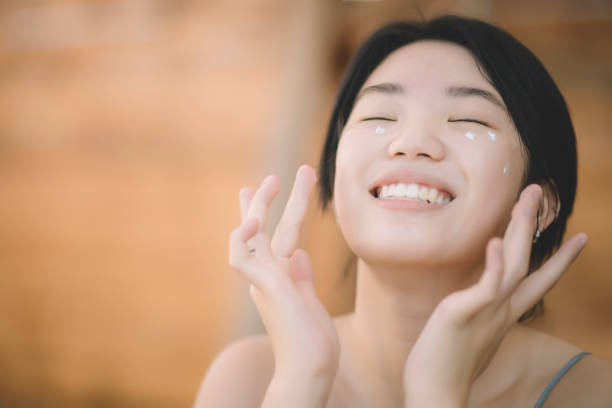 young woman taking of her face with preventive aesthetic medicine
